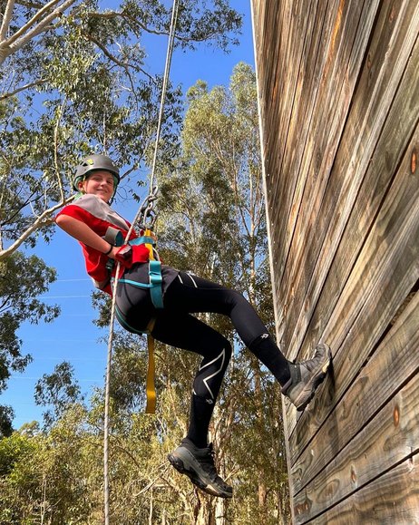 A scout abseiling down a wall